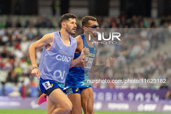 Julio Cesar Agripino dos Santos of Team Brazil celebrates with guide Romario Santos Viana a new World Record of 14:48:85 in the Men's 5000m...