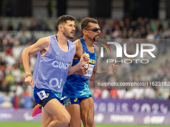 Julio Cesar Agripino dos Santos of Team Brazil celebrates with guide Romario Santos Viana a new World Record of 14:48:85 in the Men's 5000m...