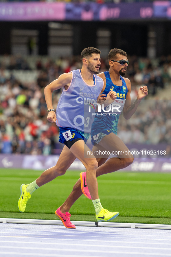 Julio Cesar Agripino dos Santos of Team Brazil celebrates with guide Romario Santos Viana a new World Record of 14:48:85 in the Men's 5000m...