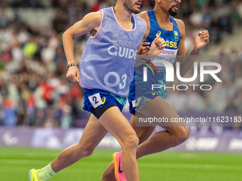 Julio Cesar Agripino dos Santos of Team Brazil celebrates with guide Romario Santos Viana a new World Record of 14:48:85 in the Men's 5000m...