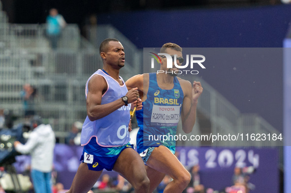 Julio Cesar Agripino dos Santos of Team Brazil celebrates with guide Romario Santos Viana a new World Record of 14:48:85 in the Men's 5000m...