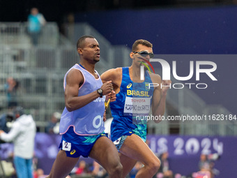 Julio Cesar Agripino dos Santos of Team Brazil celebrates with guide Romario Santos Viana a new World Record of 14:48:85 in the Men's 5000m...