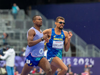 Julio Cesar Agripino dos Santos of Team Brazil celebrates with guide Romario Santos Viana a new World Record of 14:48:85 in the Men's 5000m...