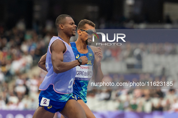 Julio Cesar Agripino dos Santos of Team Brazil celebrates with guide Romario Santos Viana a new World Record of 14:48:85 in the Men's 5000m...