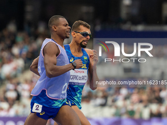 Julio Cesar Agripino dos Santos of Team Brazil celebrates with guide Romario Santos Viana a new World Record of 14:48:85 in the Men's 5000m...