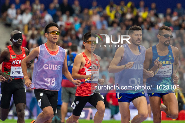 Kenya Karasawa of Team Japan and Julio Cesar Agripino dos Santos of Team Brazil compete in the Men's 5000m T11 Final on day two of the Paris...