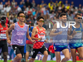 Kenya Karasawa of Team Japan and Julio Cesar Agripino dos Santos of Team Brazil compete in the Men's 5000m T11 Final on day two of the Paris...