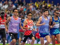 Kenya Karasawa of Team Japan and Julio Cesar Agripino dos Santos of Team Brazil compete in the Men's 5000m T11 Final on day two of the Paris...