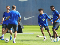 Frenkie de Jong, Ansu Fati, and Raphinha Dias train at the Joan Gamper sports city before the Champions League match against Young Boys in B...