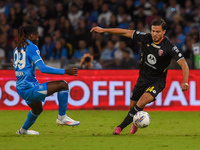 Andrea Carboni of AC Monza competes for the ball with Andre-Frank Zambo Anguissa of SSC Napoli during the Serie A match between SSC Napoli a...