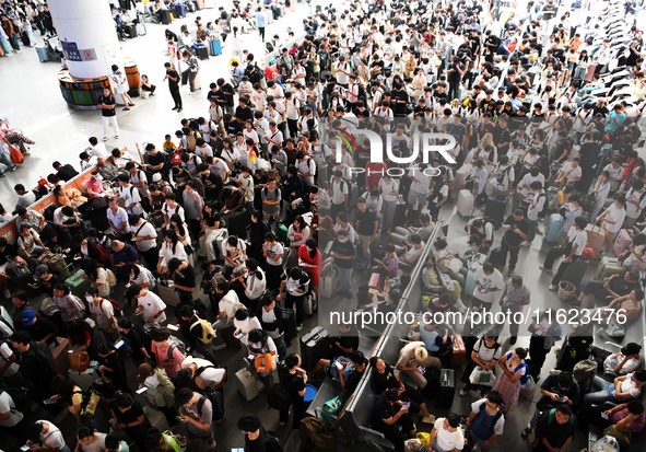 Passengers are seen in a waiting room at Nanchang Railway Station in Nanchang, China, on September 30, 2024. 