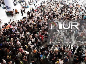 Passengers are seen in a waiting room at Nanchang Railway Station in Nanchang, China, on September 30, 2024. (