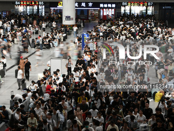 Passengers are seen in a waiting room at Nanchang Railway Station in Nanchang, China, on September 30, 2024. (