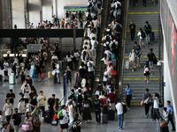 Passengers enter a waiting room after checking their tickets at Nanchang Railway Station in Nanchang, China, on September 30, 2024. (