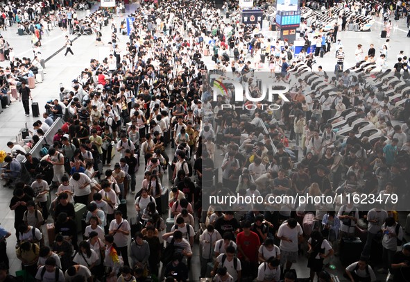 Passengers are seen in a waiting room at Nanchang Railway Station in Nanchang, China, on September 30, 2024. 