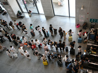 Passengers enter a waiting room after checking their tickets at Nanchang Railway Station in Nanchang, China, on September 30, 2024. (