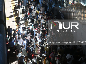 Passengers get on and off a train at Nanchang Railway Station in Nanchang, China, on September 30, 2024. (