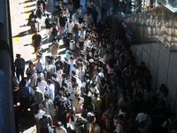 Passengers get on and off a train at Nanchang Railway Station in Nanchang, China, on September 30, 2024. (