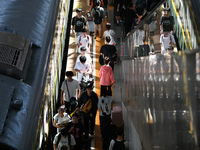 Passengers get on and off a train at Nanchang Railway Station in Nanchang, China, on September 30, 2024. (