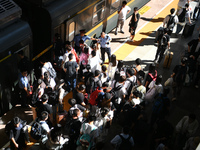 Passengers get on and off a train at Nanchang Railway Station in Nanchang, China, on September 30, 2024. (