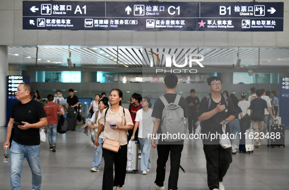 Passengers are seen in a waiting room at Nanchang Railway Station in Nanchang, China, on September 30, 2024. 