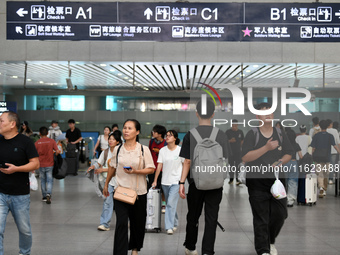 Passengers are seen in a waiting room at Nanchang Railway Station in Nanchang, China, on September 30, 2024. (