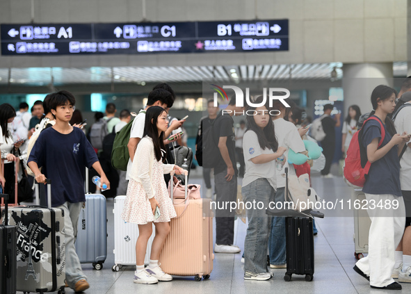 Passengers are seen in a waiting room at Nanchang Railway Station in Nanchang, China, on September 30, 2024. 