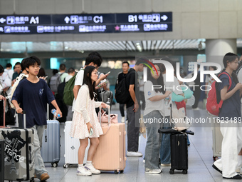 Passengers are seen in a waiting room at Nanchang Railway Station in Nanchang, China, on September 30, 2024. (