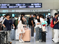 Passengers are seen in a waiting room at Nanchang Railway Station in Nanchang, China, on September 30, 2024. (