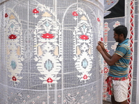 A weaver makes a Jamdani design on a cloth to decorate a ''pandal'' or a temporary platform ahead of the Durga Puja festival in Kolkata, Ind...