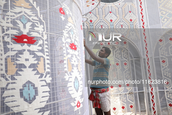 A weaver makes a Jamdani design on a cloth to decorate a ''pandal'' or a temporary platform ahead of the Durga Puja festival in Kolkata, Ind...