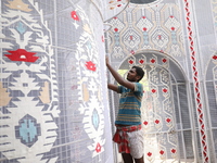 A weaver makes a Jamdani design on a cloth to decorate a ''pandal'' or a temporary platform ahead of the Durga Puja festival in Kolkata, Ind...