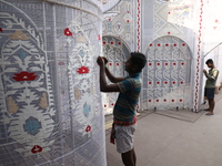 Weavers make Jamdani designs on cloth to decorate a ''pandal'' or temporary platform ahead of the Durga Puja festival in Kolkata, India, on...