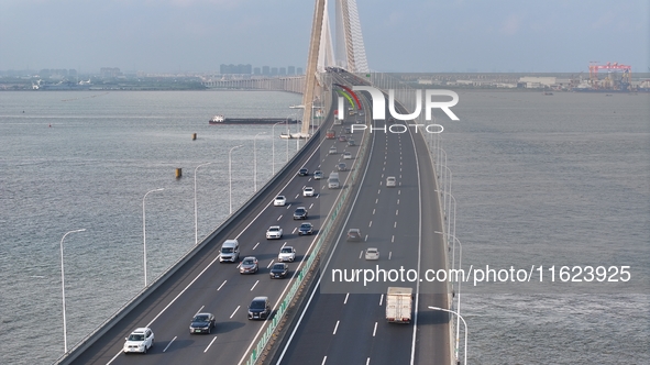 Traffic flows for several kilometers past the G15 Shenyang-Haikou Expressway of the Sutong Yangtze River Bridge in Changshu, China, on Septe...