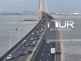 Traffic flows for several kilometers past the G15 Shenyang-Haikou Expressway of the Sutong Yangtze River Bridge in Changshu, China, on Septe...