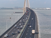 Traffic flows for several kilometers past the G15 Shenyang-Haikou Expressway of the Sutong Yangtze River Bridge in Changshu, China, on Septe...