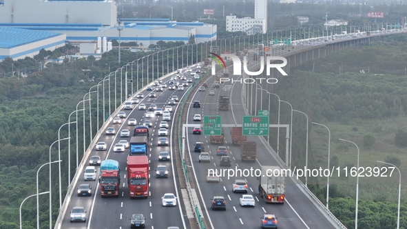 Traffic flows for several kilometers past the G15 Shenyang-Haikou Expressway of the Sutong Yangtze River Bridge in Changshu, China, on Septe...