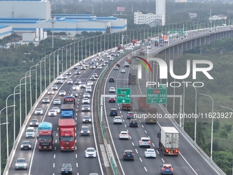 Traffic flows for several kilometers past the G15 Shenyang-Haikou Expressway of the Sutong Yangtze River Bridge in Changshu, China, on Septe...