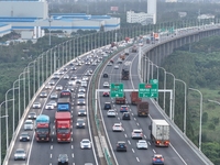 Traffic flows for several kilometers past the G15 Shenyang-Haikou Expressway of the Sutong Yangtze River Bridge in Changshu, China, on Septe...