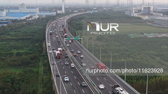 Traffic flows for several kilometers past the G15 Shenyang-Haikou Expressway of the Sutong Yangtze River Bridge in Changshu, China, on Septe...