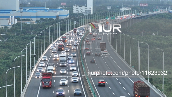 Traffic flows for several kilometers past the G15 Shenyang-Haikou Expressway of the Sutong Yangtze River Bridge in Changshu, China, on Septe...