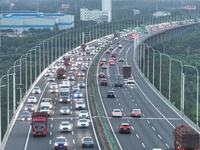 Traffic flows for several kilometers past the G15 Shenyang-Haikou Expressway of the Sutong Yangtze River Bridge in Changshu, China, on Septe...