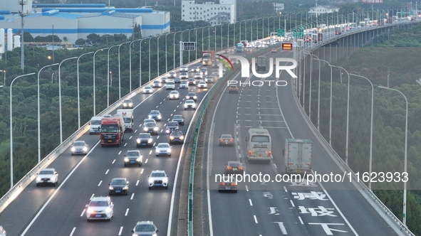 Traffic flows for several kilometers past the G15 Shenyang-Haikou Expressway of the Sutong Yangtze River Bridge in Changshu, China, on Septe...