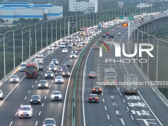 Traffic flows for several kilometers past the G15 Shenyang-Haikou Expressway of the Sutong Yangtze River Bridge in Changshu, China, on Septe...