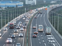 Traffic flows for several kilometers past the G15 Shenyang-Haikou Expressway of the Sutong Yangtze River Bridge in Changshu, China, on Septe...