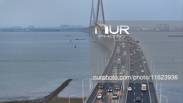 Traffic flows for several kilometers past the G15 Shenyang-Haikou Expressway of the Sutong Yangtze River Bridge in Changshu, China, on Septe...