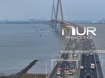 Traffic flows for several kilometers past the G15 Shenyang-Haikou Expressway of the Sutong Yangtze River Bridge in Changshu, China, on Septe...