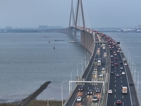 Traffic flows for several kilometers past the G15 Shenyang-Haikou Expressway of the Sutong Yangtze River Bridge in Changshu, China, on Septe...