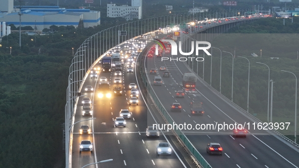 Traffic flows for several kilometers past the G15 Shenyang-Haikou Expressway of the Sutong Yangtze River Bridge in Changshu, China, on Septe...