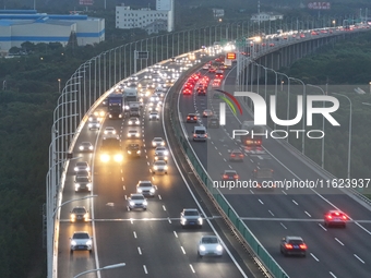 Traffic flows for several kilometers past the G15 Shenyang-Haikou Expressway of the Sutong Yangtze River Bridge in Changshu, China, on Septe...